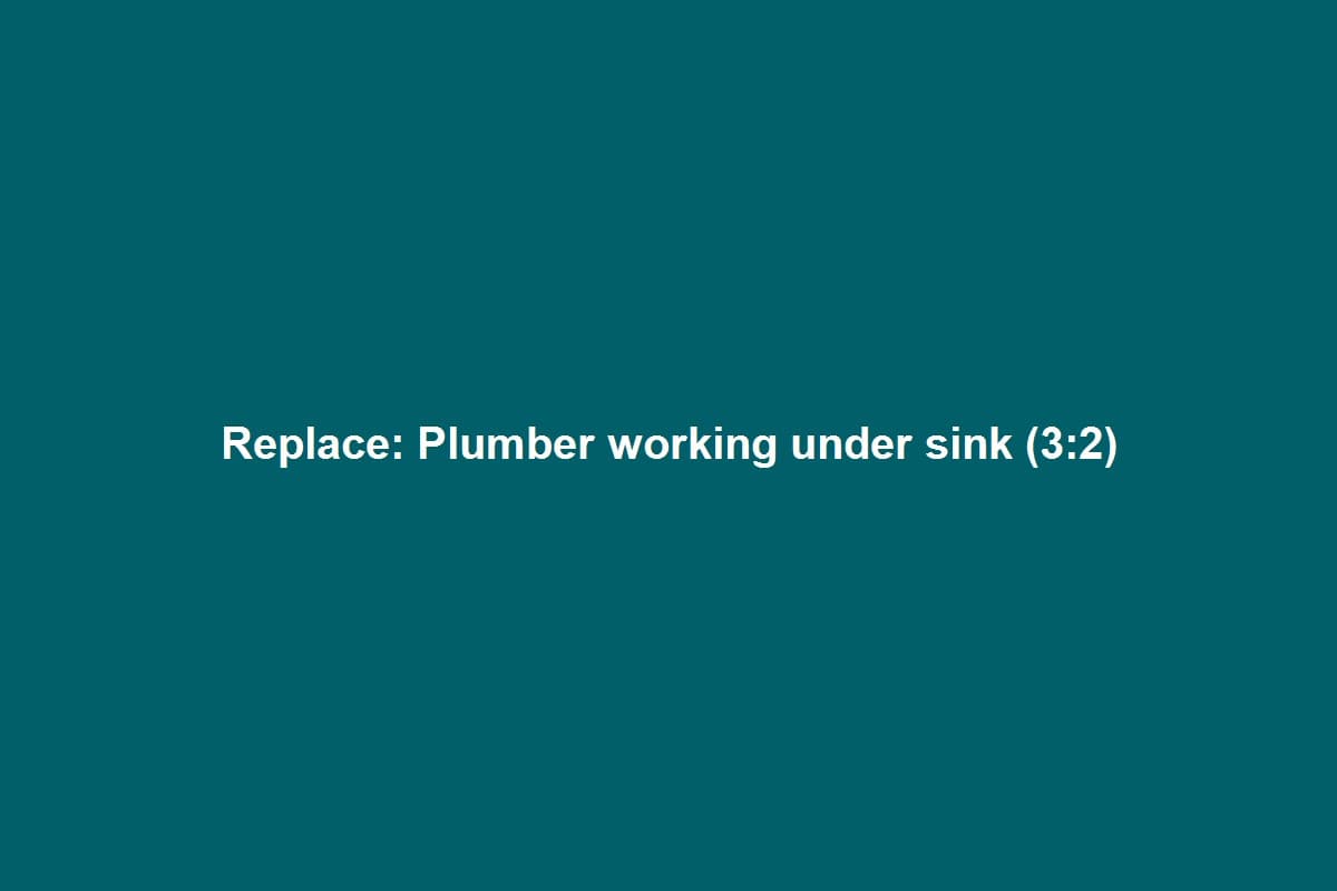 Plumber hands installing a faucet and supply lines under a kitchen sink